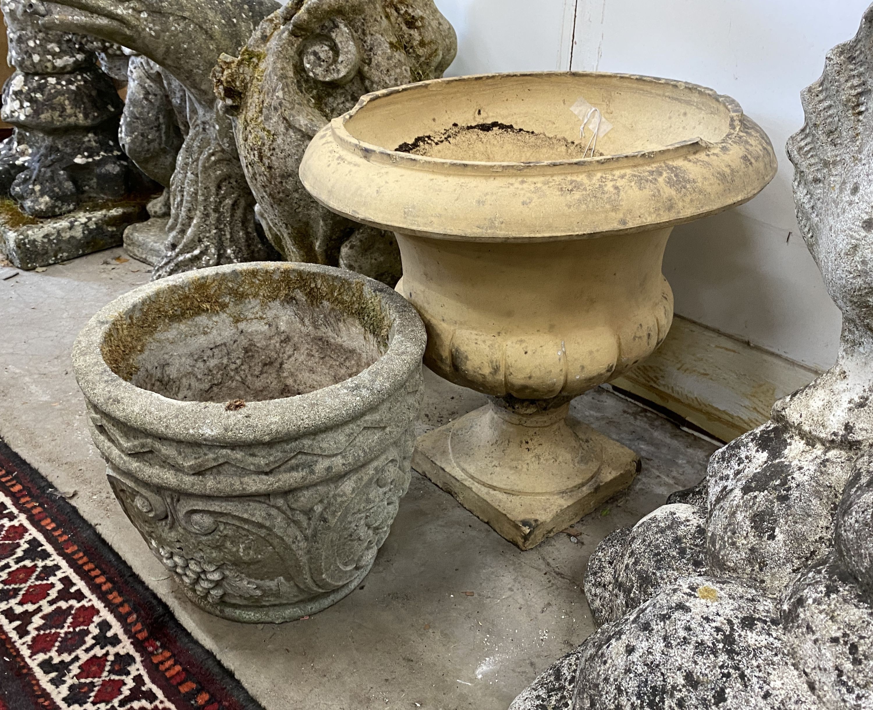 An earthenware campana garden urn, diameter 45cm, height 42cm together with a smaller reconstituted stone garden planter